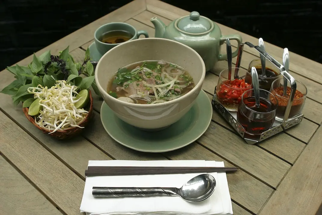 Bowl of pho sitting on a table